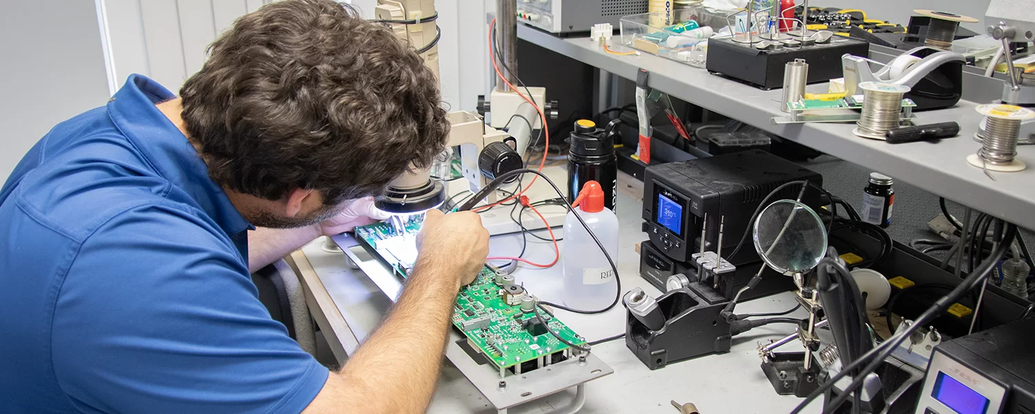 Technician repairing diagnostic imaging equipment