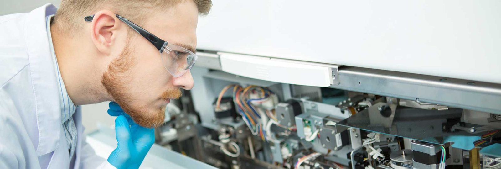 Biomedical technician inspecting equipment components